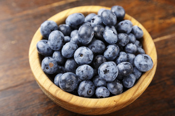 ripe organic bog whortleberry in a wooden plate