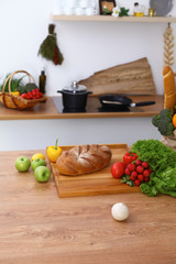 Desk  with many fresh vegetables and fruits in the kitchen. Cooking, vegetarian and shopping concept.