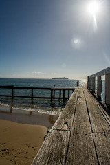 Fototapeta premium A pier on an Australian beach, leading into the water