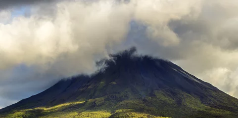 Tuinposter Cloud-topped Arenal Volcano National Park. Active volcano in Costa Rica with visible lava flow from 1968 eruption. © stellamc