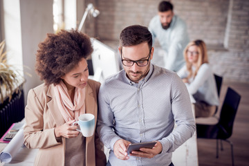 Business colleagues in modern office using tablet