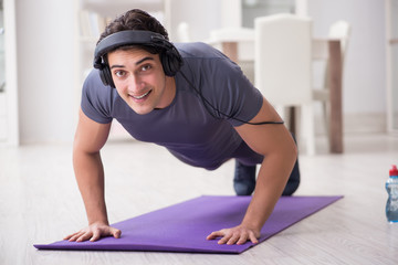 Man doing sports at home and listening to music