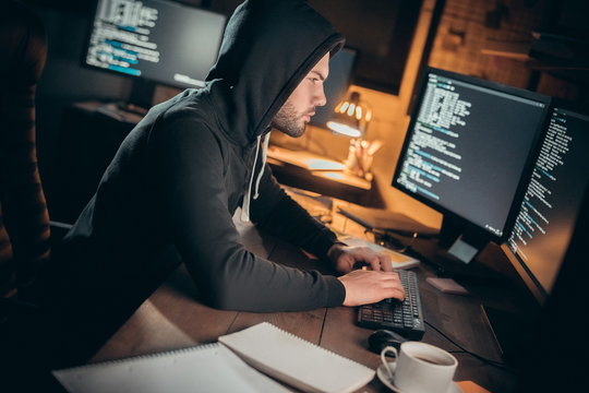 Young male financial hacker at office sitting typing code - Powered by Adobe