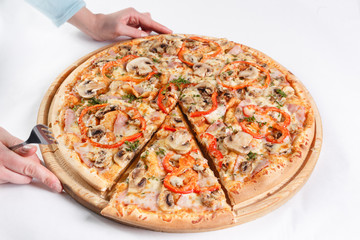 Pizza box delivery concept. Open box with hot tasty italian sliced pizza with salmon, eel, seafood, olives, basil, tomato, mushrooms.