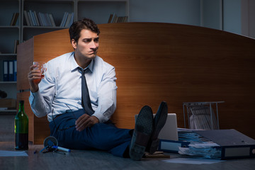 Stressed businessman working overtime in depression
