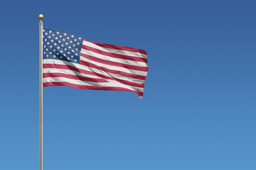 USA Flag of in front of a clear blue sky