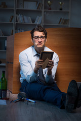 Sad employee in office missing his wife after divorce separation