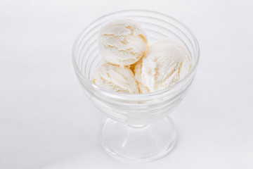 Vanilla ice cream on white background. Scoops of vanilla ice cream in glasses bowl