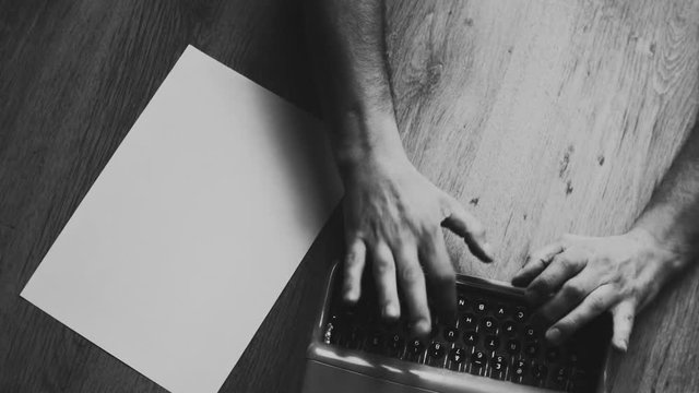 Person typing on a vintage typewriter with vintage 35mm camera, after an adventurous trip, Taking notes and ideas . Different styles available in my gallery color and Black and white