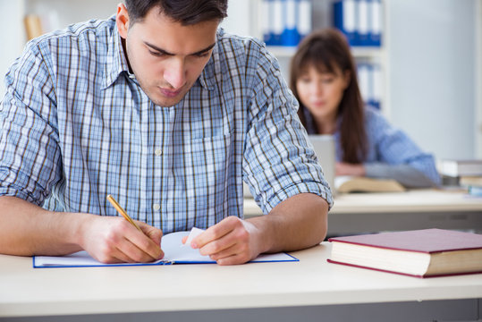 Students sitting and studying in classroom college