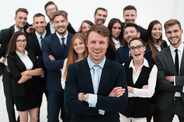 smiling businessman standing on background of her business team.