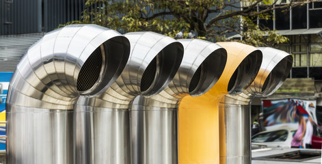 Five shiny stainless steel ventilation pipes atop the Pre-Columbian Gold Museum in San Jose, Costa...