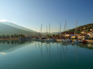 Fototapeta na wymiar Yachts anchored at sunrise in the harbour in Amaliapoli, Thessaly, Greece