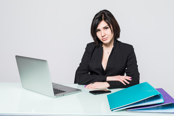 beautiful business woman smile sitting at the desk working using laptop looking at screen isolated over white background