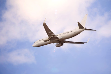Fototapeta na wymiar plain passenger airplane starting in a cloudscape