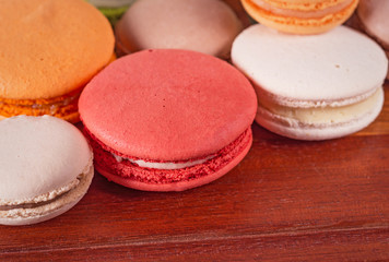 Close up colorful French or Italian macaron on wood table