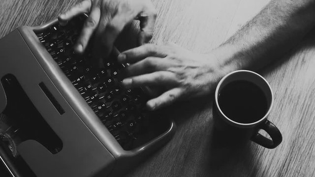 Person typing on a vintage typewriter with vintage 35mm camera, after an adventurous trip, Taking notes and ideas . Different styles available in my gallery color and Black and white