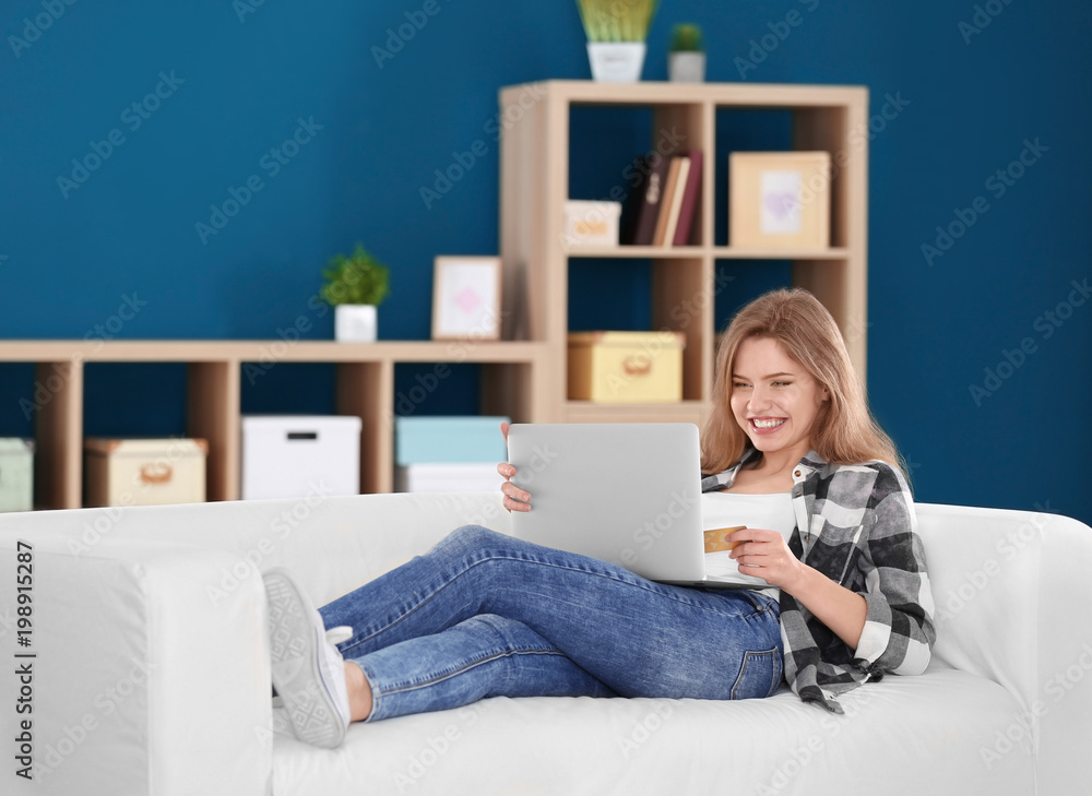 Poster young woman shopping online with credit card and laptop at home