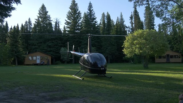 Landed helicopter with spinning propellers