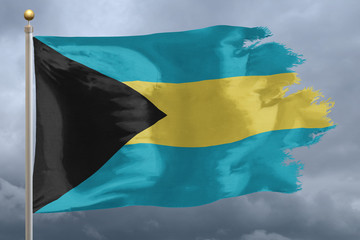 Bahamas Flag with torn edges in front of a stormy sky