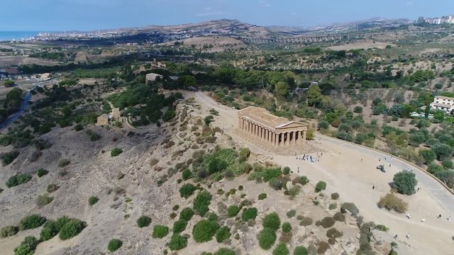 Aerial circling  around Temple of Concordia in Italian Tempio della Concordia an ancient Greek temple in the Valley of the Temples or Valle dei Templi in Agrigento on south coast of Sicily Italy 4k