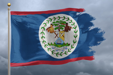 Obraz premium Belize Flag with torn edges in front of a stormy sky