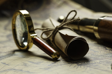 Retro compass with old map and spyglass