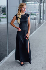 Fototapeta premium Attractive lady in long evening dress on the street