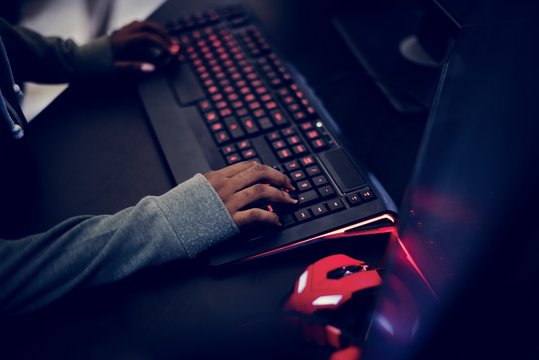 Closeup of hands working on computer keyboard