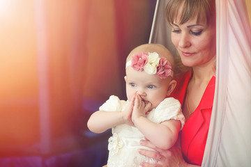 Baby in the arms of the girl. Mom holds her child in her arms. H