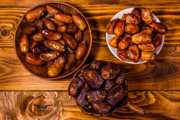 Date fruits on a wooden table. Top view