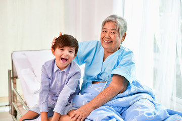 Patient Concept. Grandma's in the hospital. Waiting for someone to visit. Grandchildren visit grandma at the hospital. Grandma is happy to meet grandchildren.