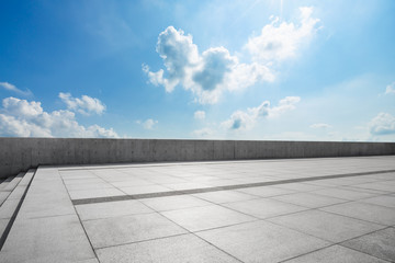 empty square floor and blue sky with white clouds in the daytime