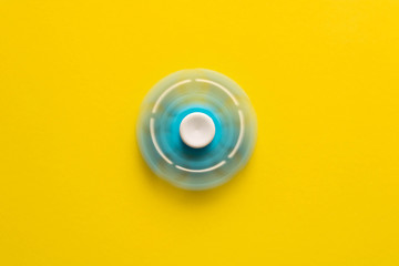 The rotating spinner . Isolated on yellow background