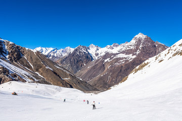 ski in chile on a sunny day with lots of snow.