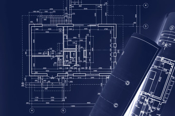 civil building sketch drawings, rolled blueprints on dark blue surface. architect workplace background. double exposure.