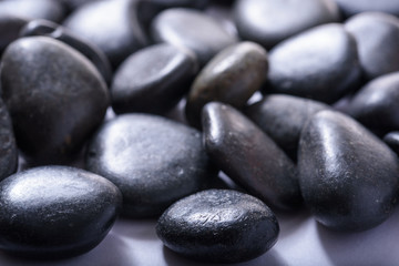 A group of small dark stones, spa stones