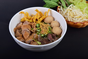 Spicy tom yum noodle soup with boiled pork and pork ball