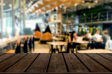 Selected focus empty brown wooden table and Coffee shop or restaurant blur background with bokeh image. for your photomontage or product display.