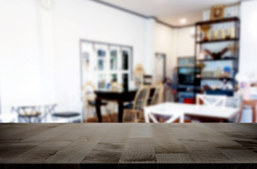 Selected focus empty brown wooden table and Coffee shop or restaurant blur background with bokeh image. for your photomontage or product display.