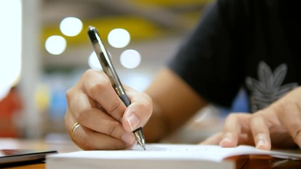 Close up shot hands of woman writing on paper notebook select focus shallow depth of field