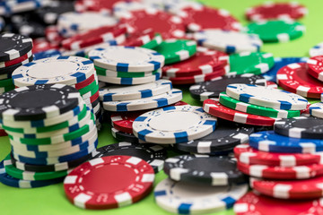 many poker chips isolated on a green background