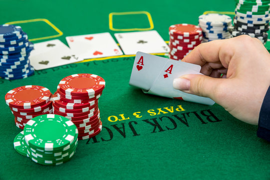 Woman hand holding two aces, close up