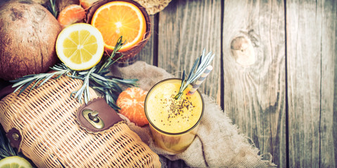 summer composition with fresh orange juice on a wooden background, concept of refreshing summer drinks and summer relaxation