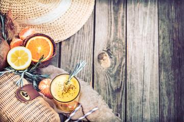 summer composition with fresh orange juice on a wooden background, concept of refreshing summer drinks and summer relaxation