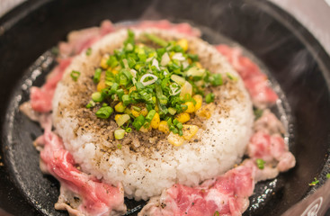 Rice and pork with corn served in hot pan