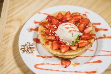 Toast With Icecream and fresh strawberry with whipping cream on white plate.