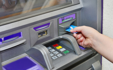 Woman holding card ,using ATM