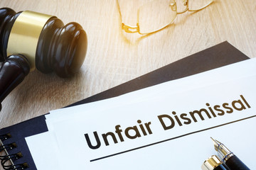 Documents unfair dismissal and gavel in a court. - obrazy, fototapety, plakaty