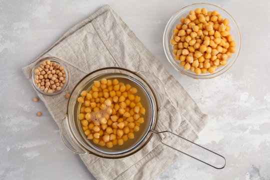 Boiled chickpeas, raw chickpeas, water from boiled chickpeas - aquafaba. Replace egg in baking for vegan recipe, top view, copy space. Healthy diet concept.